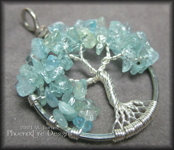 Beautiful, genuine gemstone blue aquamarine - the birthstone of March - brings the color of the sea to the sterling silver wire of this stunning, custom Tree of Life pendant.