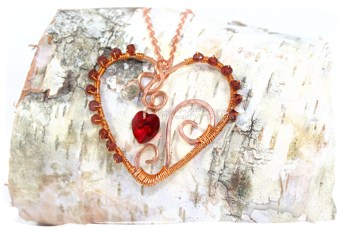 Wire wrapped copper heart pendant by Phoenix Fire Designs with dark red garnet gemstone accents and swarovski crystal heart pendant handmade wire wrap necklace on etsy