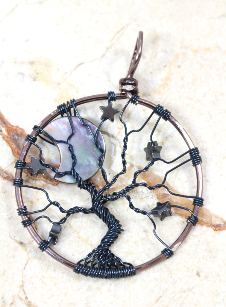 Wire wrapped in silver plated gunmetal wire, this celestial tree of life features an iridescent black lip shell crescent moon and hematite stars by PhoenixFire Designs on etsy.