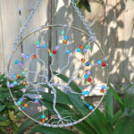 Silver anodized aluminum wire wrapped tree of life 8" suncatcher with rainbow glass fire cracked beads, perfect garden art, or handmade wall art for your home. By PhoenixFire Designs.