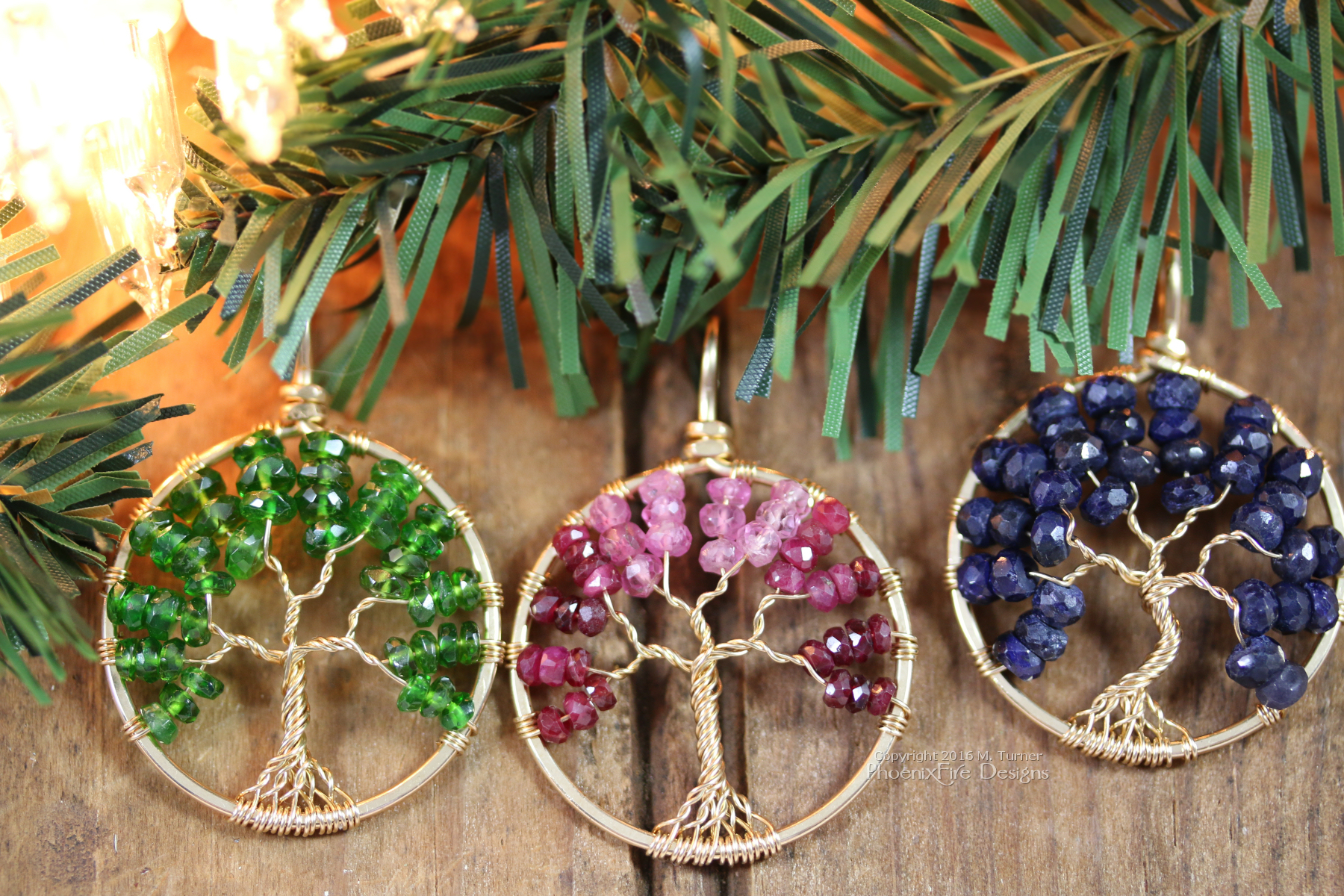 Three 14k gf Tree of Life Pendants handmade by PhoenixFire Designs featuring emerald green Chrome Diopside, an Ombre of shaded Ruby, and deep Blue Sapphire.